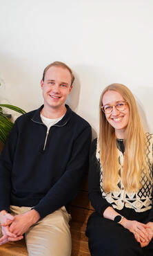 Zwei Azubis sitzen auf einer Holzbank Zwei Azubis sitzen auf einer Holzbank